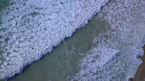 Aerial Top View Waves Break on Beach