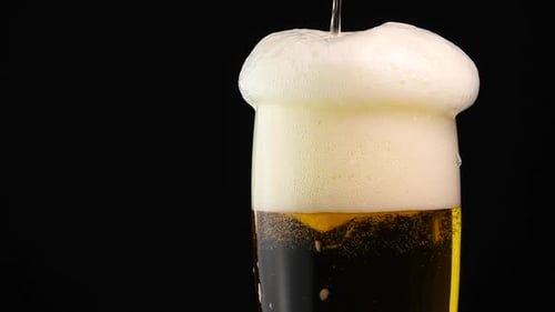 Refreshing Beer Pouring Into Glass, Overflowing With Foam