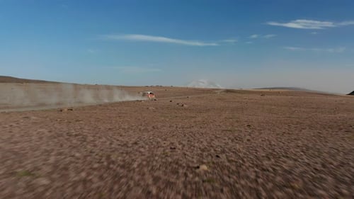 Drone View Car Driving Fast in Desert Highlands in Iceland