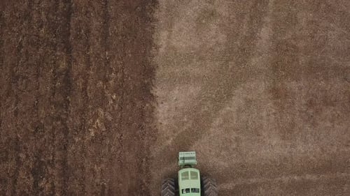 Aerial View of Tractor Plowing Rural Field