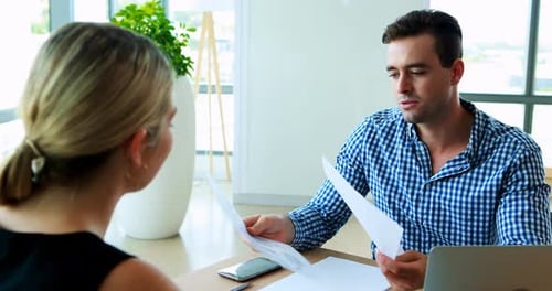 Two Colleagues Talking at Office Table