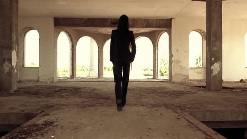 Unrecognizable Brunette Walks in Forsaken Building