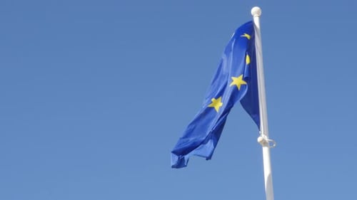 European Union Flag Waving Against a Blue Sky