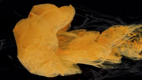 Abstract Yellow Ink Swirling in Black Liquid