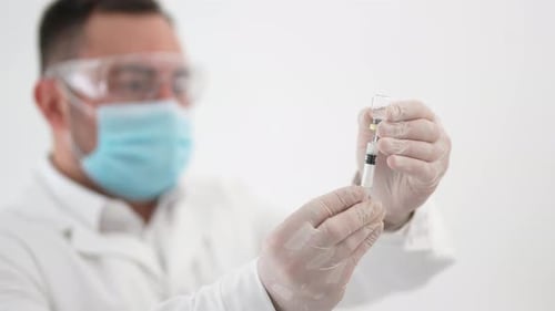 Medical Worker Filling Syringe With Medicine