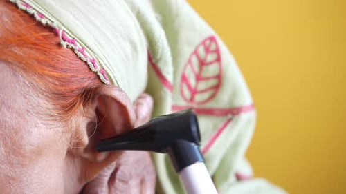 Examining Senior Patient Ear By Otoscope Close Up