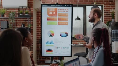 Diverse Team Analyzes Business Data in Office