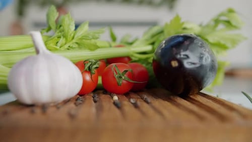 Close-up of Fresh Beautiful Vegetables on Wooden Cutting Board in Kitchen