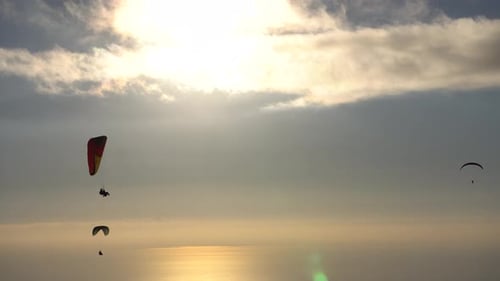 Paragliders Sailing Silently at Sunset