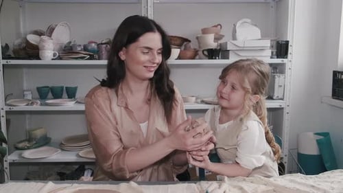 Woman and Child Working with Clay in Studio