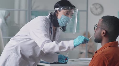 Medical Professional Taking Nasal Swab Sample From Patient