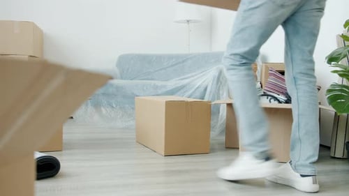 Man Stacking Boxes In A New Home
