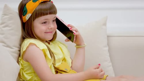 Adorable Girl Talking on the Phone Indoors