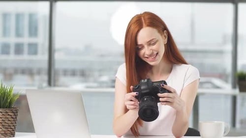 Smiling Young Woman Holding a Digital Camera