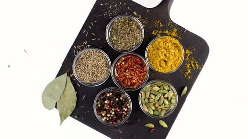 Spices Displayed on Serving Board Rotating Overhead
