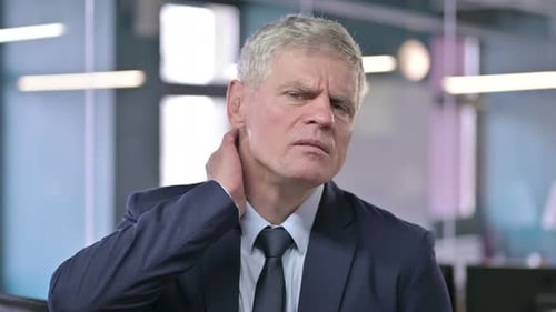 Portrait of Tired Middle Aged Businessman Having Neck Pain