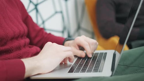 Colleagues Programmers Are Looking on Monitor and Typing on Keyboard in Office