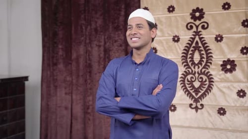 Muslim man standing crossed hands