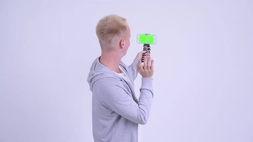 Happy Young Blonde Handsome Man Vlogging with Phone