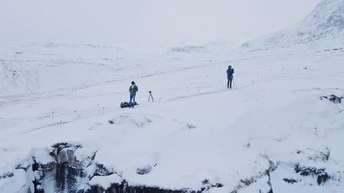 Winter Mountain Landscape With Two People in Iceland