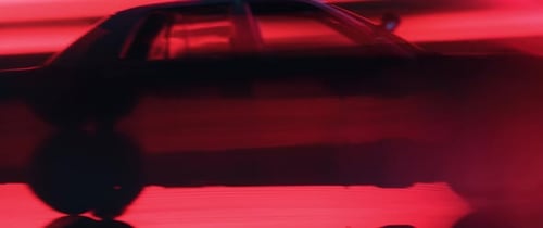 Police Car Speeds in Neon-Lit City