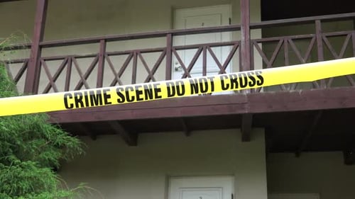Crime Scene Tape Blocking Building Entrance