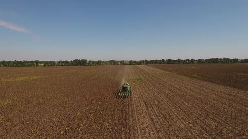 Sunflower Combine Harvester And Rural Landscape