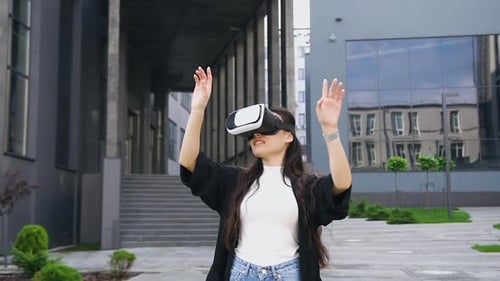 Woman Using VR Headset in Urban Environment