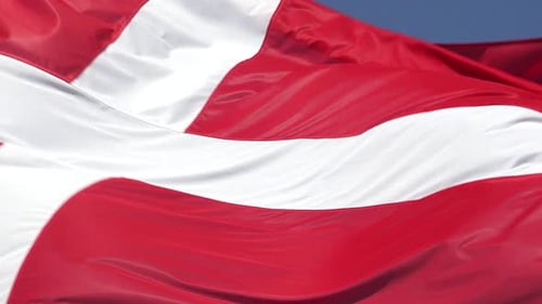 Danish Flag Waving Proudly Against a Blue Sky