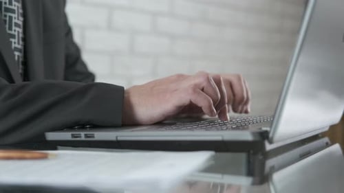 Hands Meditate and Type on Laptop at Work