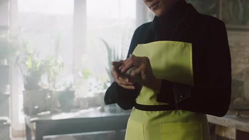 Woman Shaping Clay in Bright Studio