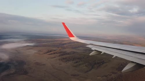 The Aircraft Performs a Descent From a Height for the Approach. Flying Over the Fields and Forests.