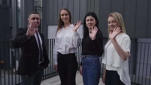 Group of Positive Business People Waving Smiling Looking at Camera