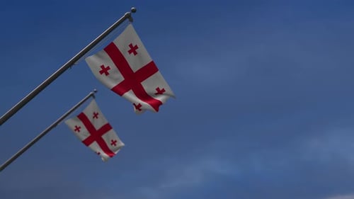 Realistic Waving Georgian Flag Against Blue Sky