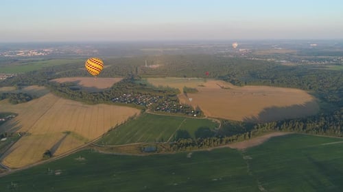 Aerial View of Hot Air Balloons Flying Over Countryside