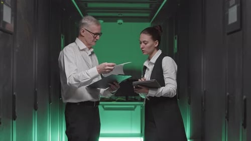 IT-Specialists Talking in Server Room