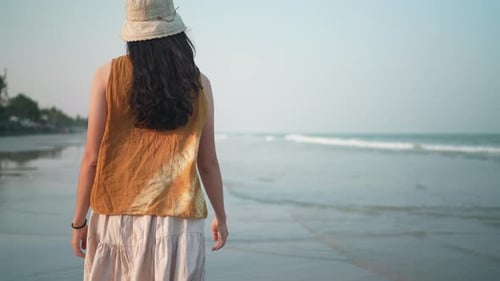 Asian woman walking slow-motion on the beach, summer vacation on the tropical sea beach