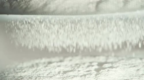 Sifting The Flour Through A Sieve