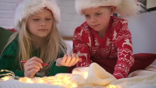 Children Writing Letters to Santa Indoors at Christmas