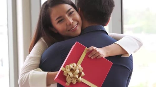 Romantic Couple Giving Gift to Lover at Restaurant
