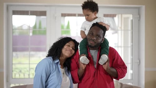 Happy Family Smiling Together Indoors at Home
