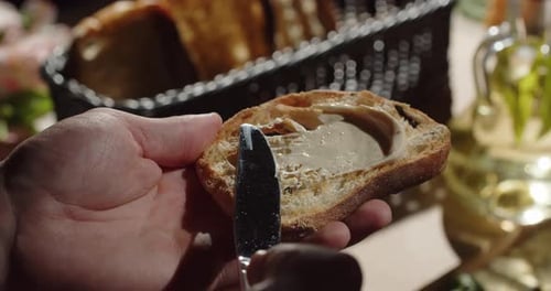 Spread Butter On A Piece Of Fragrant Fresh Toasted Bread On The Grill
