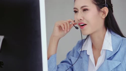 Customer Support Agent or Call Center with Headset Talking to Customer on Phone