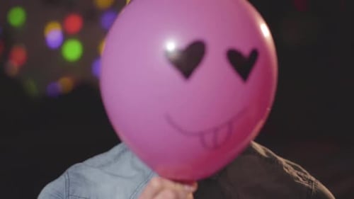 Young Adult with Balloon at Party