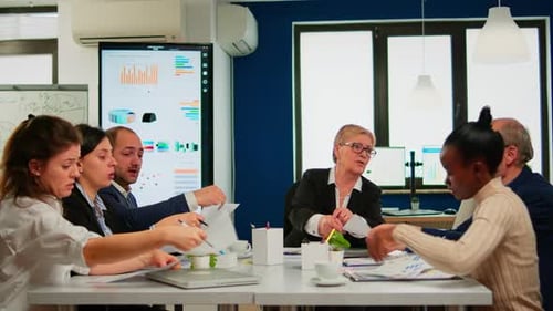 Business Team Collaborating on Data Analysis in Office