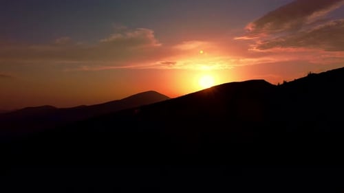 Aerial view of colorful sunrise on top of Carpathian Mountains range, morning fog