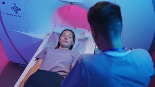 Woman Talking to Doctor during MRI Procedure