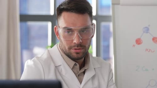 Scientist Explaining Chemistry on Whiteboard Indoors