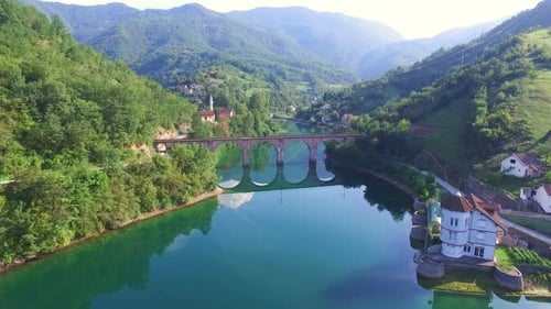 Flug über Fluss und alte Steinbrücke in Bosnien