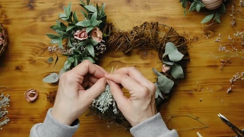 Hands Decorating Spring Floral Wreath